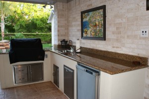 The outdoor kitchen was finished to match the room addition with stucco fascia and granite counters.
