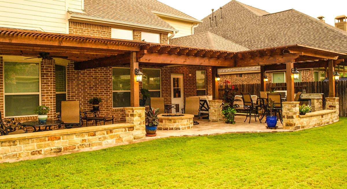 Extended outdoor living area with pergola and firepit