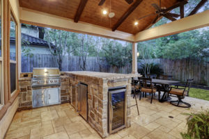 Outdoor kitchen with gabled roof patio cover