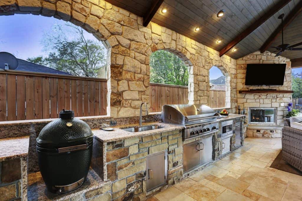 Outdoor kitchen with grill and green egg.