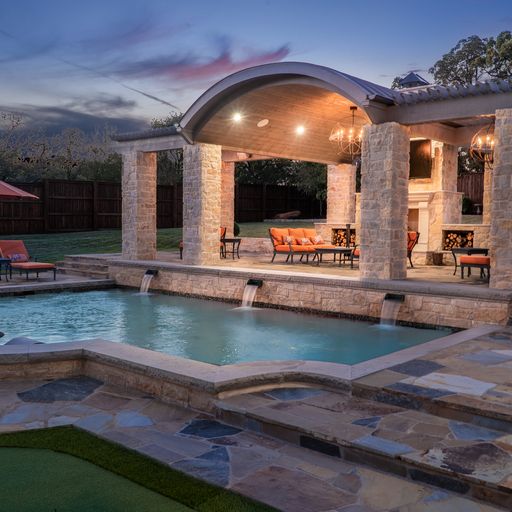Patio with sconces, an outdoor water feature