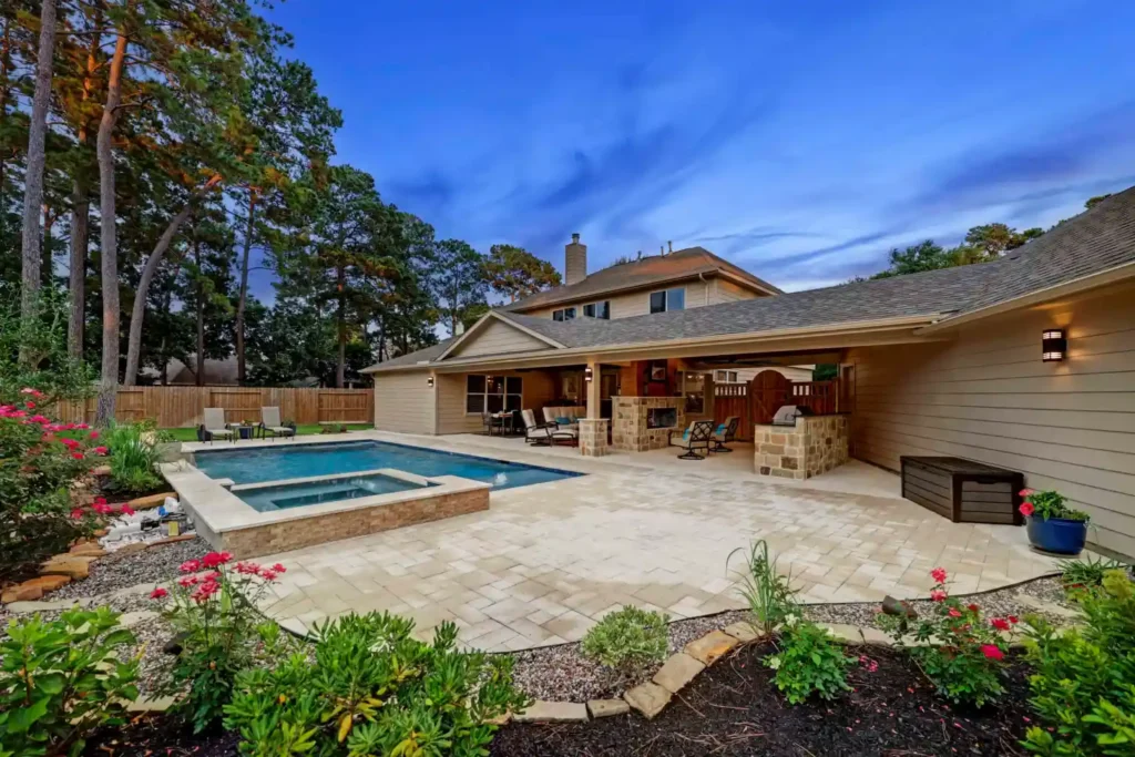 Outdoor living with fireplace and kitchen in Spring